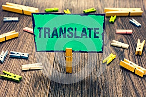 Word writing text Translate. Business concept for Another word with same equivalent meaning of a target language Clothespin holdin photo