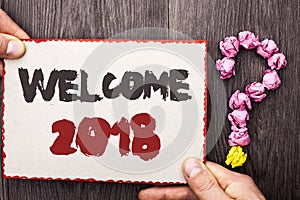 Word writing text Welcome 2018. Business concept for Celebration New Celebrate Future Wishes Gratifying Wish written on Cardboard photo