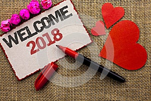 Word writing text Welcome 2018. Business concept for Celebration New Celebrate Future Wishes Gratifying Wish written on Cardboard photo
