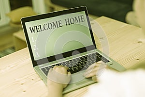 Word writing text Welcome Home. Business concept for Expression Greetings New Owners Domicile Doormat Entry woman laptop