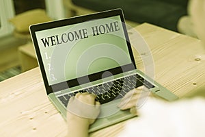 Word writing text Welcome Home. Business concept for Expression Greetings New Owners Domicile Doormat Entry woman laptop photo