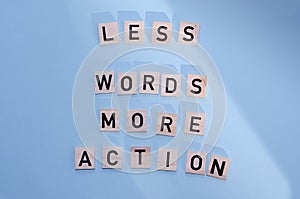 Word writing text LESS WORDS MORE ACTION. Business concept written on wood block.