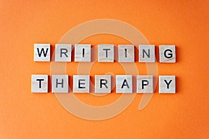 Word writing therapy. The phrase is laid out in wooden letters top view. Motivation. Orange flat lay background