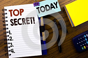 Word, writing Top Secret. Business concept for Military Top Secret written on book note paper on the wooden background. With attac