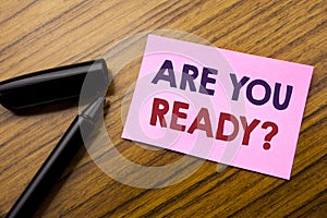 Word, writing Are You Ready. Business concept for Future Preparation Plan Written on sticky note red paper, wooden background with