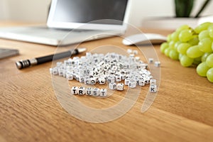 Trust word written on cube shape white blocks on wooden Business table