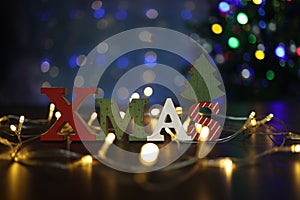 The word XMAS on a background of beautiful bokeh