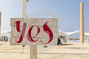 Word yes on the information board on the beach