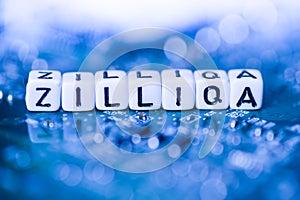 Word ZILLIQA formed by alphabet blocks on mother cryptocurrency photo