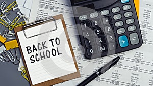 The words Back to school written on a white notebook. Work and study concept