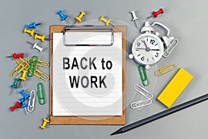 The words Back to work written on a white notebook