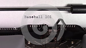 The words `Baseball 101 ` being typed on a typewriter