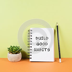 The words build good habits are standing on a notebook, change lifestyle, healthy and positive attidude, motivation concepts photo