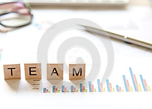 Words of business Team concepts collected in crossword with wooden cubes, select focus.