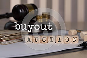 Words BUYOUT AUCTION  composed of wooden dices