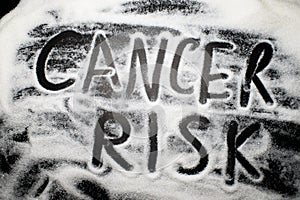 Words cancer risk written with and in sugar, health concern concept