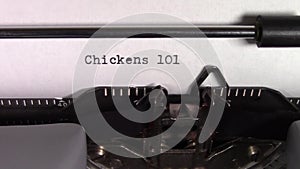 The words `Chickens 101 ` being typed on a typewriter