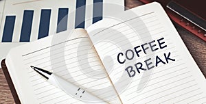 The words Coffee Break written on a white notebook. Work and study concept