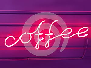 Words of coffee from a pink neon tube
