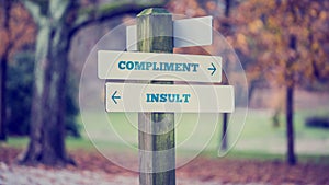 Words Compliment and Insult in a conceptual image photo