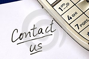 The words Contact us with a cellular phone