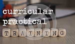 Words CURRICULAR PRACTICAL TRAINING composed of wooden dices