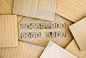 Words Declutter Your Life make by black alphabet stamps on cardb