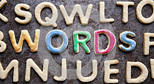 WORDS, decorated amongst letter shaped cookies, close-up