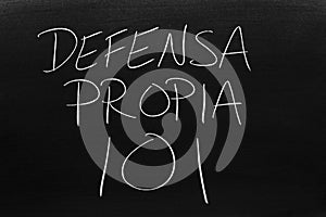 Defensa Propia 101 On A Blackboard.  Translation: Self Defense 101 photo