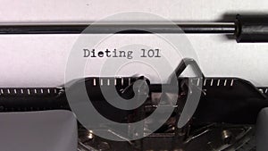 The words `Dieting 101 ` being typed on a typewriter