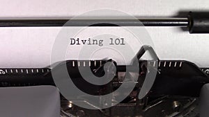 The words `Diving 101` being typed on a typewriter