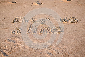 The Words `Drop Us a Line` Written in the Sand