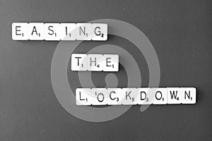 The words - Easing the lockdown - spelt out on black with copy space