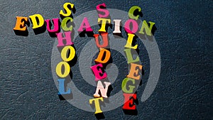 The words Education, School, Student, College built of colorful wooden letters on a dark table.