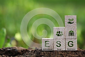 words ESG on a wood block and Future environmental conservation.