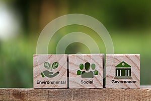 words ESG on a wood block and Future environmental conservation.