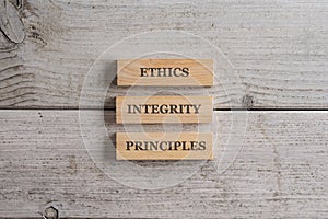 Words Ethics, Integrity and Principles written on three stacked wooden blocks
