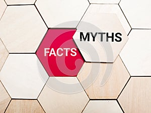 Words facts versus myths on wooden hexagon. Business concept.