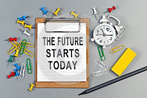 The words The future starts today written on a white notebook