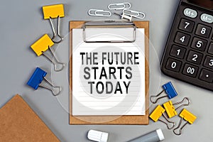 The words The future starts today written on a white notebook