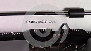 The words `Geography 101 ` being typed on a typewriter