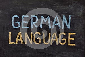 The words German Language handwritten with chalk on a blackboard