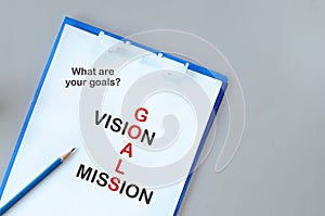 Words of goals, vision and mission on notepad