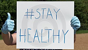 The words `hashtag stay healthy` written on a sign.