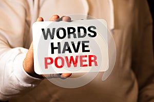Words have Power - Businesswoman holding blackboard with text