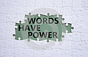 Words have power symbol. White puzzle with words Words have power. Beautiful grey green background. Business and Words have power