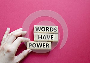 Words have power symbol. Wooden blocks with words Words have power. Beautiful red background. Businessman hand. Business and Words