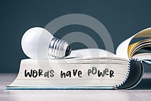 Words have power text with light bulb on the pages