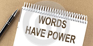 WORDS HAVE POWER text on a notepad with pen, business