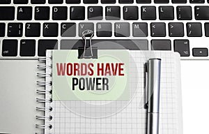 Words have power text on notepad and red pencil